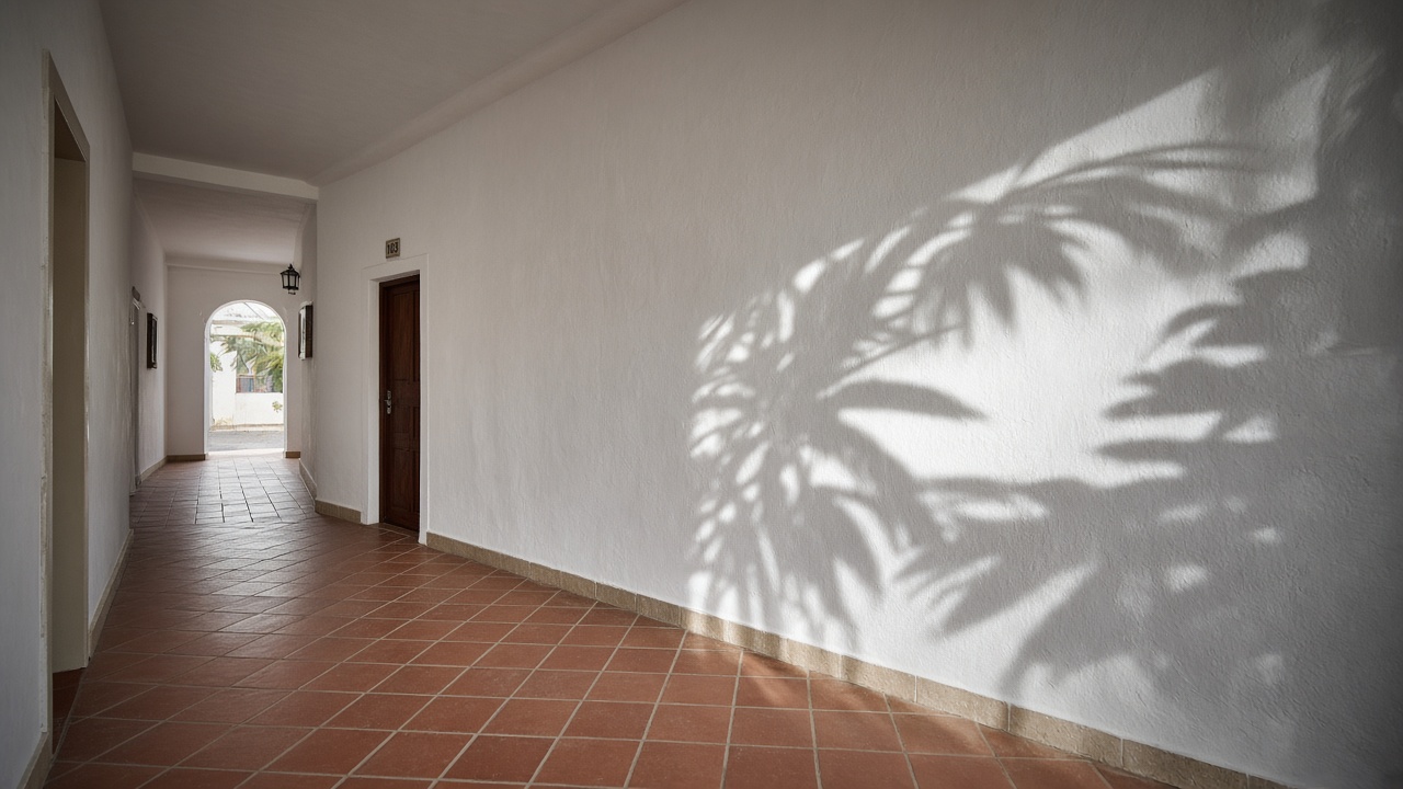 Sunlit corridor in a Mediterranean office building with terracotta flooring